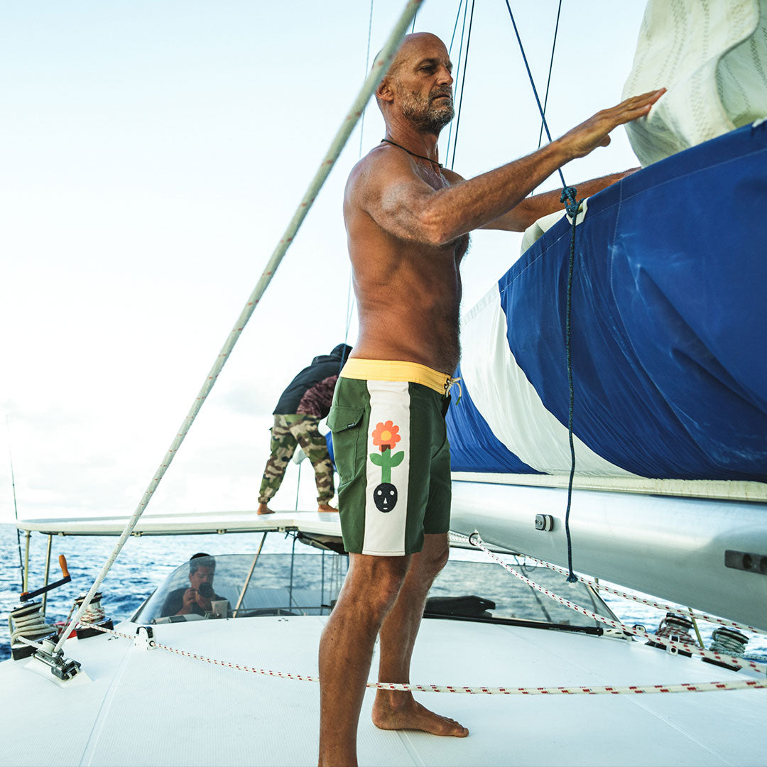 Jeff Johson packing away a sail on a boat