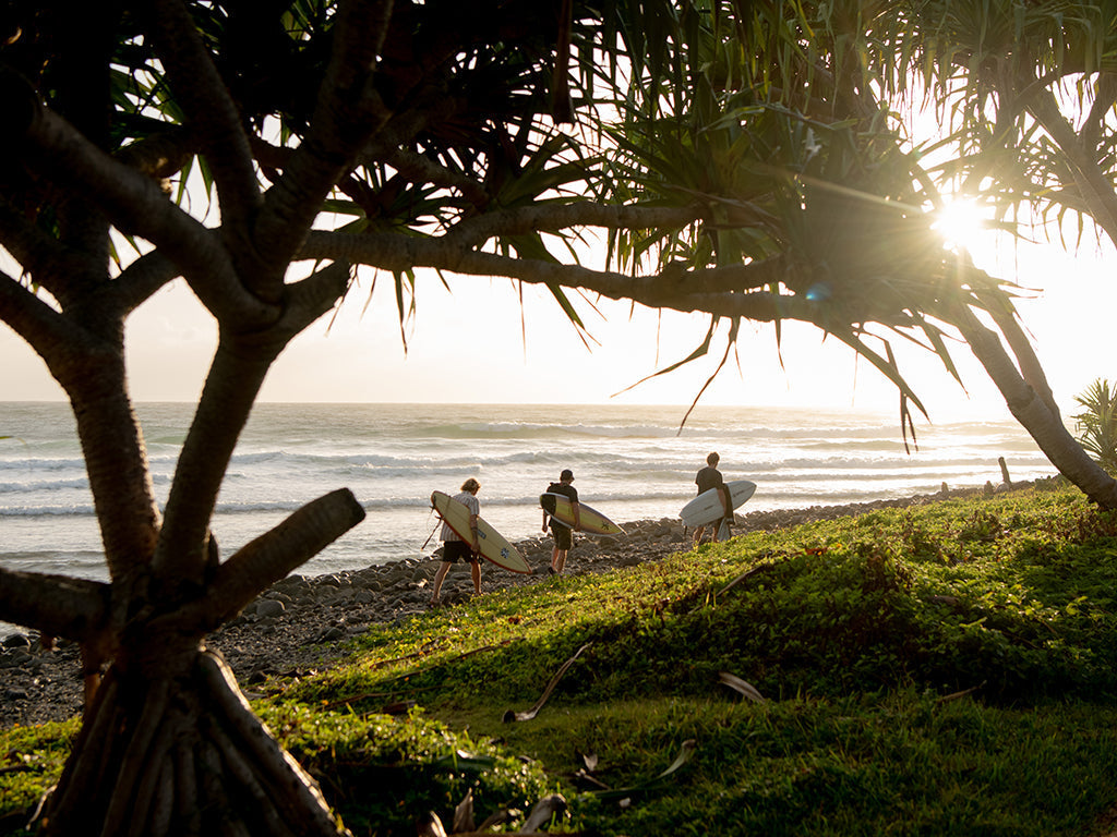 The image captures a peaceful, early morning or late afternoon moment, filled with anticipation and calm before a surf session.