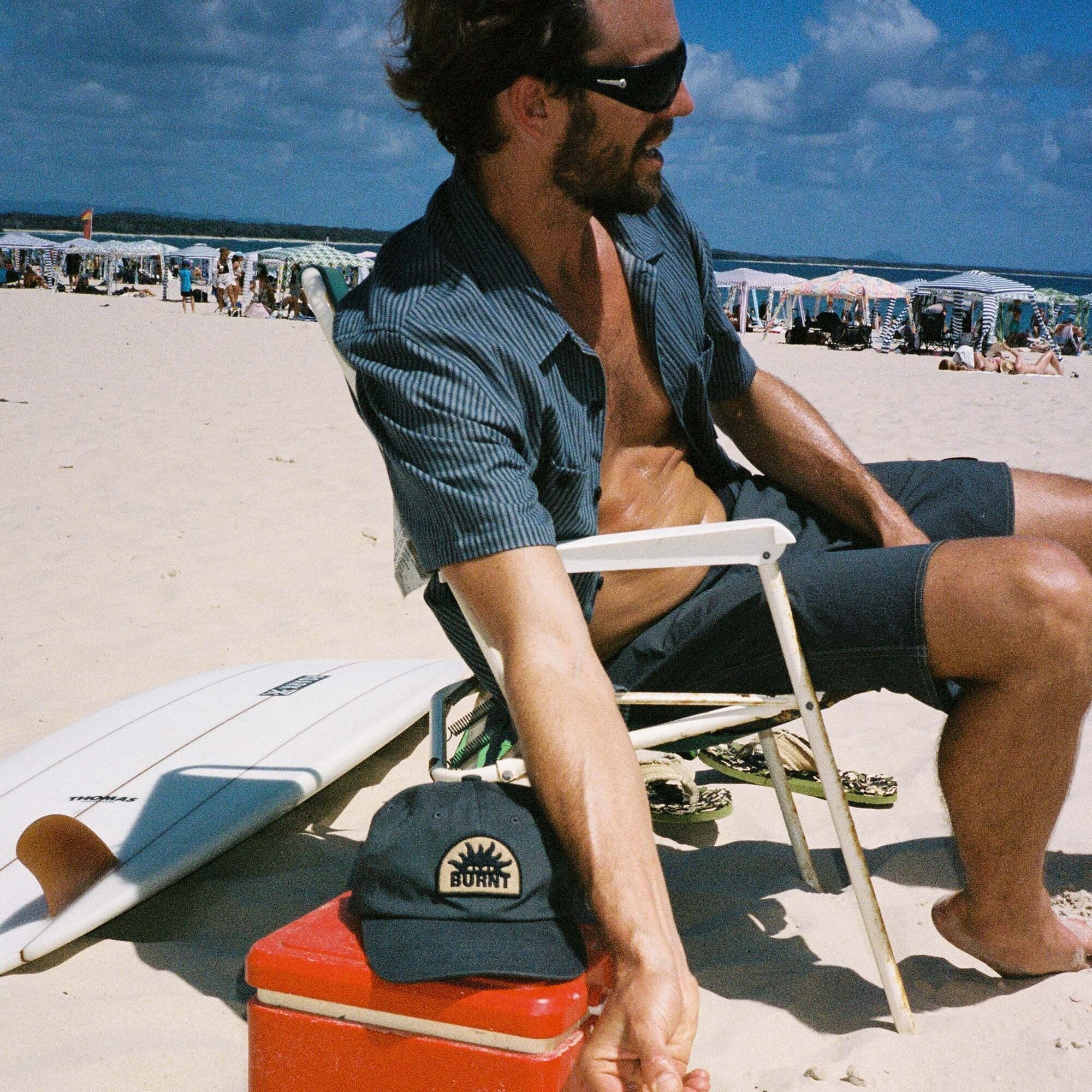 Summer adventure vibes with a stylish burnt collection hat and sunglasses, perfect for leisure and vacation.